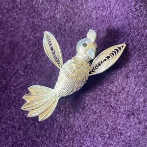 Intricately designed silver-tone bird brooch. Excellent used condition.
